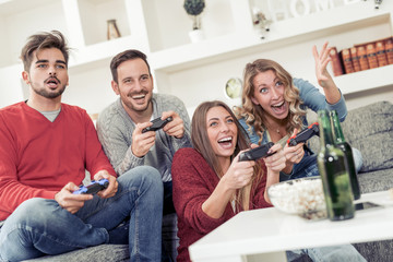 Wall Mural - Group of friends playing video games together.