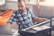 Confident Accomplished Musician Using His Laptop