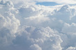 canvas print picture - Aerial view from the plane of fluffy rain cloud in daytime - Cloudscape