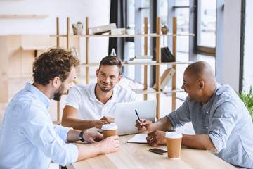 Canvas Print - multicultural business people working on laptop at meeting in office