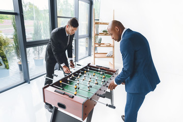 Wall Mural - concentrated business people playing table football in office