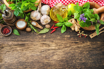 Wall Mural - Fresh herbs and spices on wooden table
