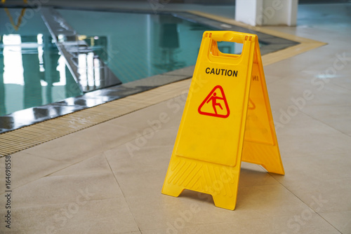 Fotografie, Obraz caution wet floor warning sign near swimming pool