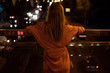 © allenkayaa - Young woman watching the view night city road from bridge