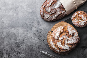 Delicious fresh bread on rustic background