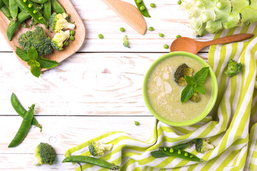 Wall Mural - Broccoli and green peas puree soup decorated with mint