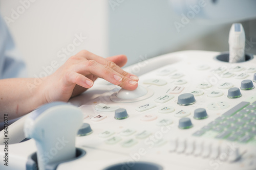Fotografia, Obraz young woman doctor's hands close up preparing for an ultrasound device scan