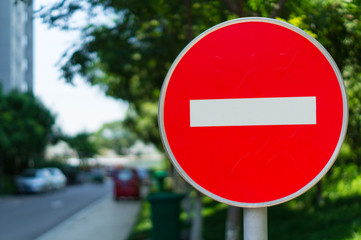 Red Stop Street Sign with City at the Background