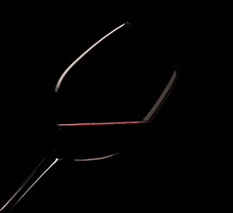 Glass of red wine on a black background