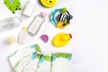 Babies Goods Diaper, Baby Powder, Cream, Shampoo, Oil On White Background With Copy Space. Top View Or Flat Lay.