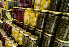 Colorful Stacked Rows Of Glass Canning Jars Containing Preserved Food.