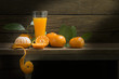 Still Life Orange and  orange juice light in the dark on a wooden table