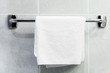 Towel hanging on a metal bar in the bathroom