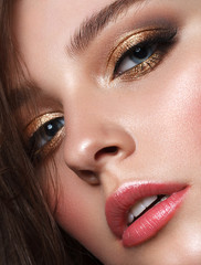 Beautiful young model with evening make up, perfect skin. Trendy golden eye-shadows