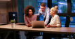 © .shock - Multiethnic startup business team in night office