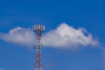 Mobile phone communication antenna tower with the blue sky and clouds