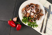 Cooked Appetizing Tasty Fried Mushrooms On White Plate. Spring Harvest Of Mushrooms Cooked For A Festive Table. Healthy Vegetarian Food On A Dark Stone Background.