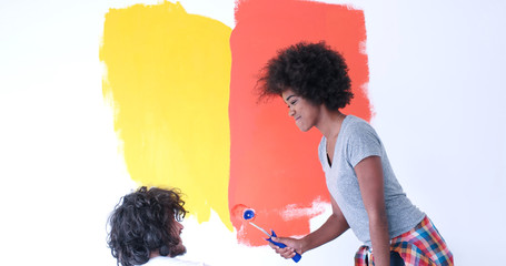 Wall Mural - multiethnic couple painting interior wall