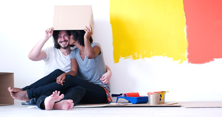 Wall Mural - young multiethnic couple playing with cardboard boxes