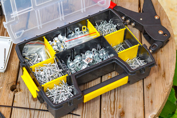 Rivet tool and rivets of various sizes in the storage box