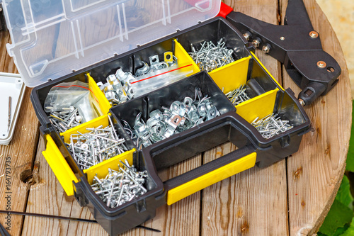 Fotografie, Obraz Rivet tool and rivets of various sizes in the storage box