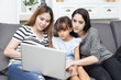 © Jestercine - Happy family woman and kid using laptop at home, happy family concept, 3 person