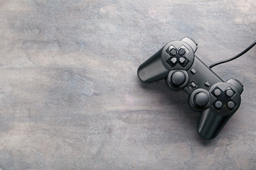 Black joystick on a grey wooden table