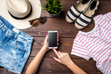 Wall Mural - Casual female clothes on wooden background. Top view