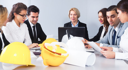 Wall Mural - Mature blonde woman leads meeting of architects