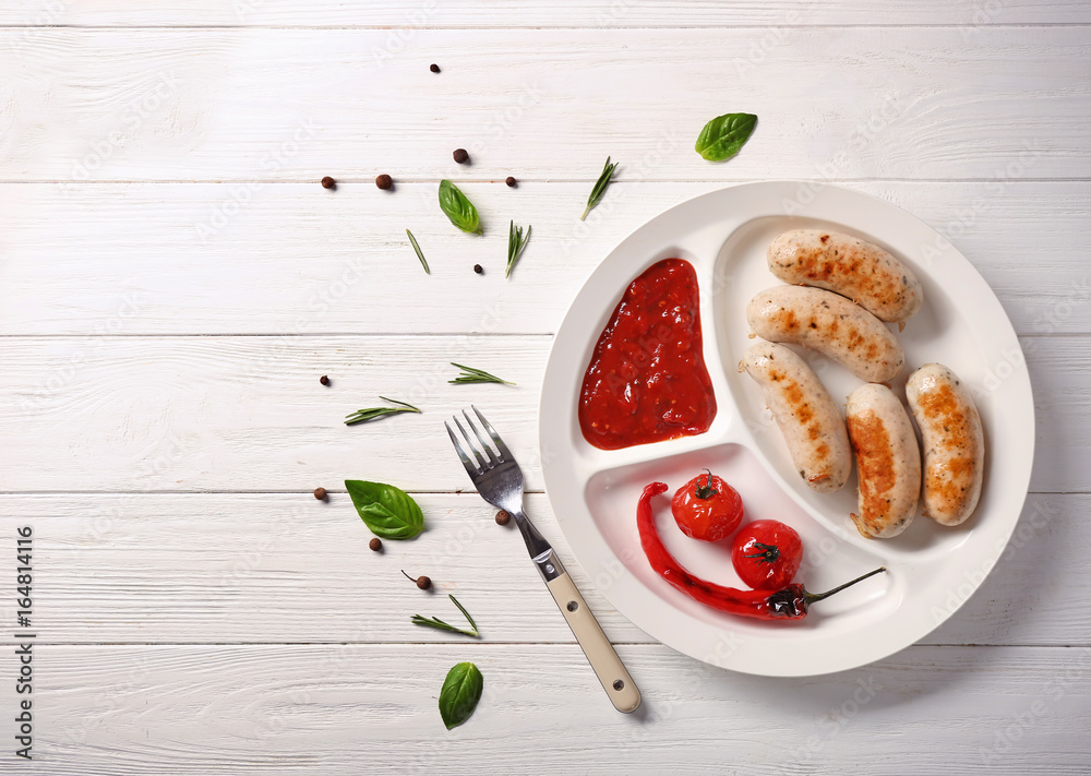 Composition with delicious grilled sausages on white wooden table