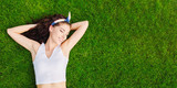 Fototapeta Młodzieżowe - Beautiful young woman lies on the grass. Fresh natural summer concept. View from the top.