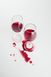 © LIGHTFIELD STUDIOS - close-up view of wineglasses with red wine and wine spilled isolated on white