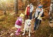 © gpointstudio - Kids and dog on leash in autumnal forest