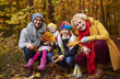 © gpointstudio - Family picking leafs on the fall season