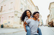 © Iryna - Smiling afro american couple of lovers having fun in city street in summer time -tourism, travel, people, leisure and teenage concept.