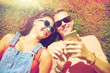 © Syda Productions - happy teenage couple smartphone lying on grass