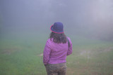 Fototapeta  - Cute girl in the middle of a foggy haze.