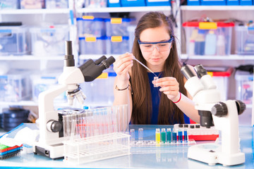 Sticker - A teenage girl in a school laboratory in chemistry and biology classes