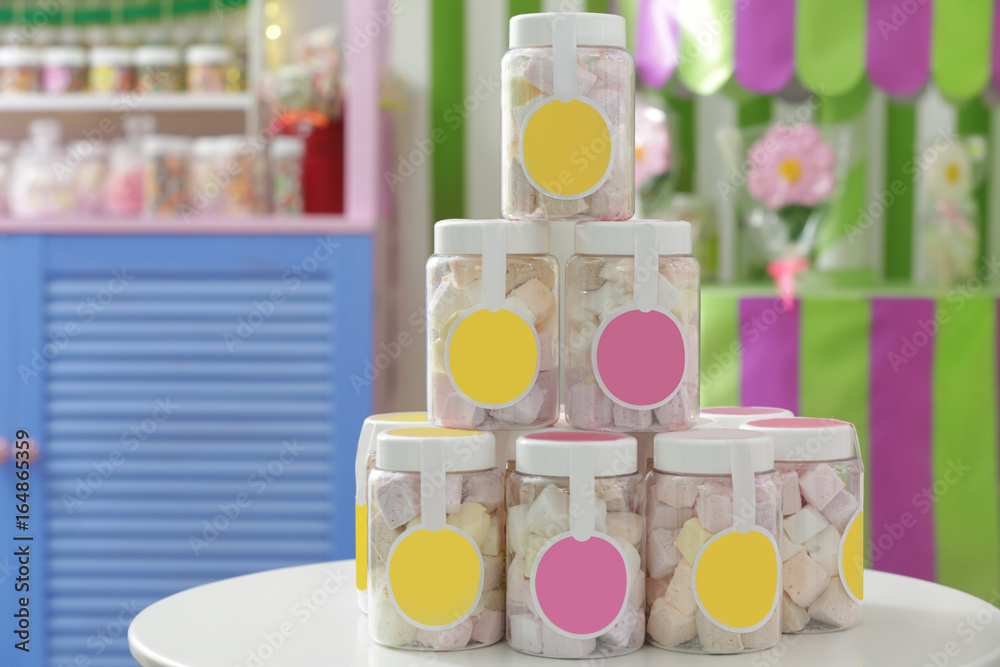 Tasty marshmallow in jars at candy shop