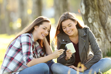 Poster - Two friends watching media in their smart phones