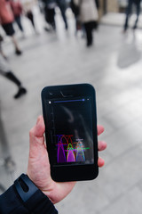 a smartphone showing cluttered wifi signals in a public place.