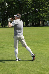 Poster - Young man playing golf on course in sunny day