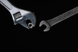 One adjustable wrench, gives a spanner nut on a black background