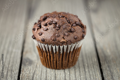 Fotografie, Obraz Chocolate Chip Muffin on Rustic Wooden Board