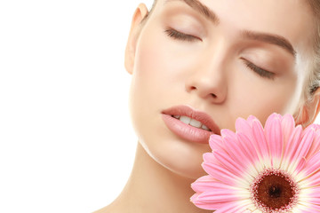 Canvas Print - Closeup view of beautiful young woman with natural lips makeup and flower on white background