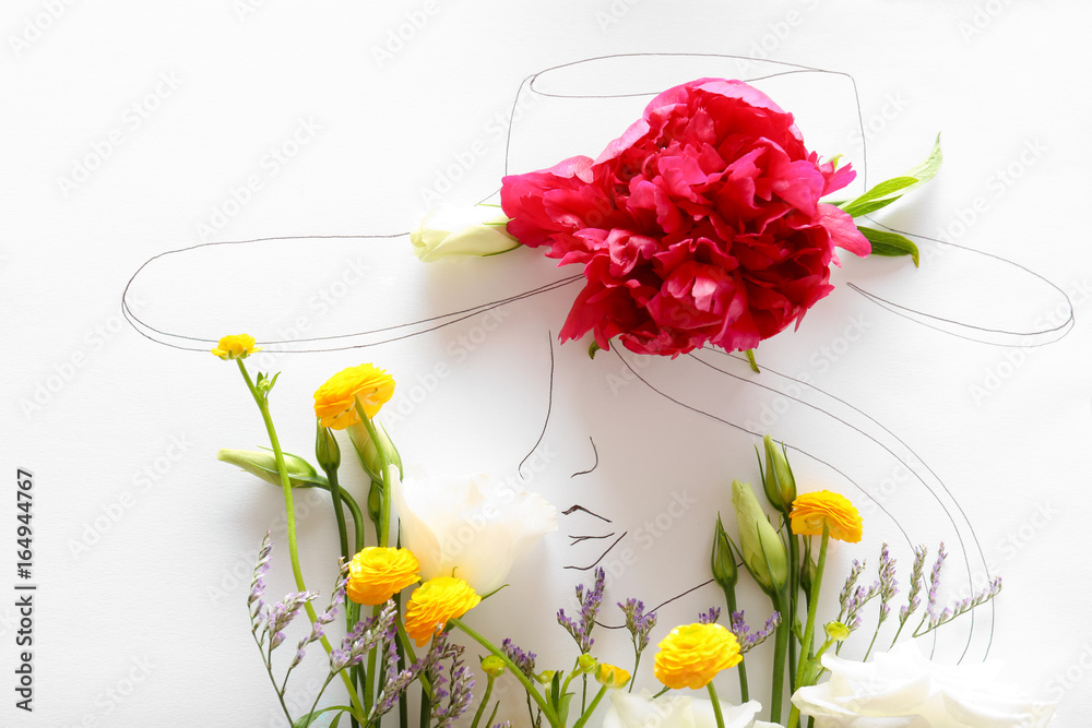 Composition of different flowers and drawn woman on paper. Creativity concept
