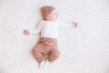 Wall Mural - Cute little baby sleeping on plaid at home