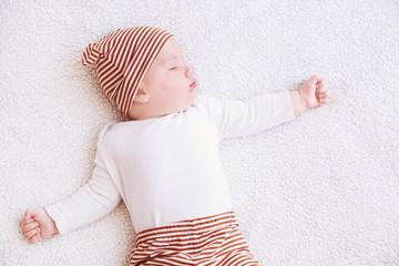 Wall Mural - Cute little baby sleeping on plaid at home