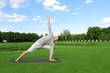 © Africa Studio - Young man practicing yoga outdoors