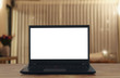 © tomertu - living room with open laptop and empty white screen for copy space